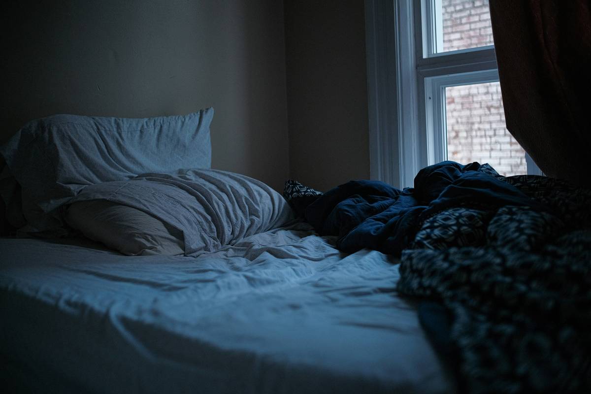 bedroom setup demonstrating effective night time routines for better sleep with cooling fan and minimal electronics