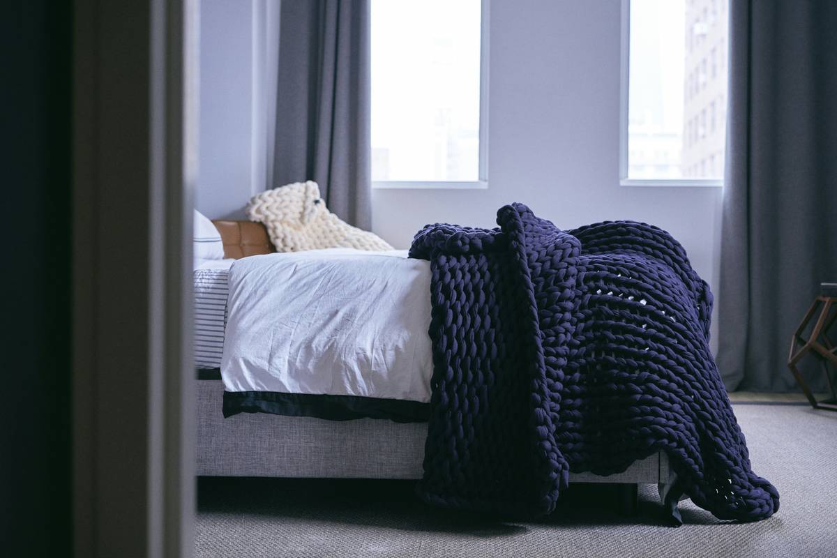 techniques for improving sleep quality illustrated with a person sleeping peacefully in a dark, cool bedroom with blackout curtains and no electronics